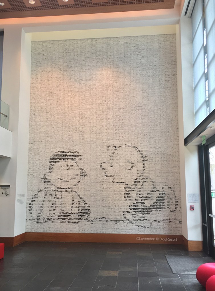 A 2-story sized mural of Lucy and Charlie Brown inside the Charles M. Schulz Museum.